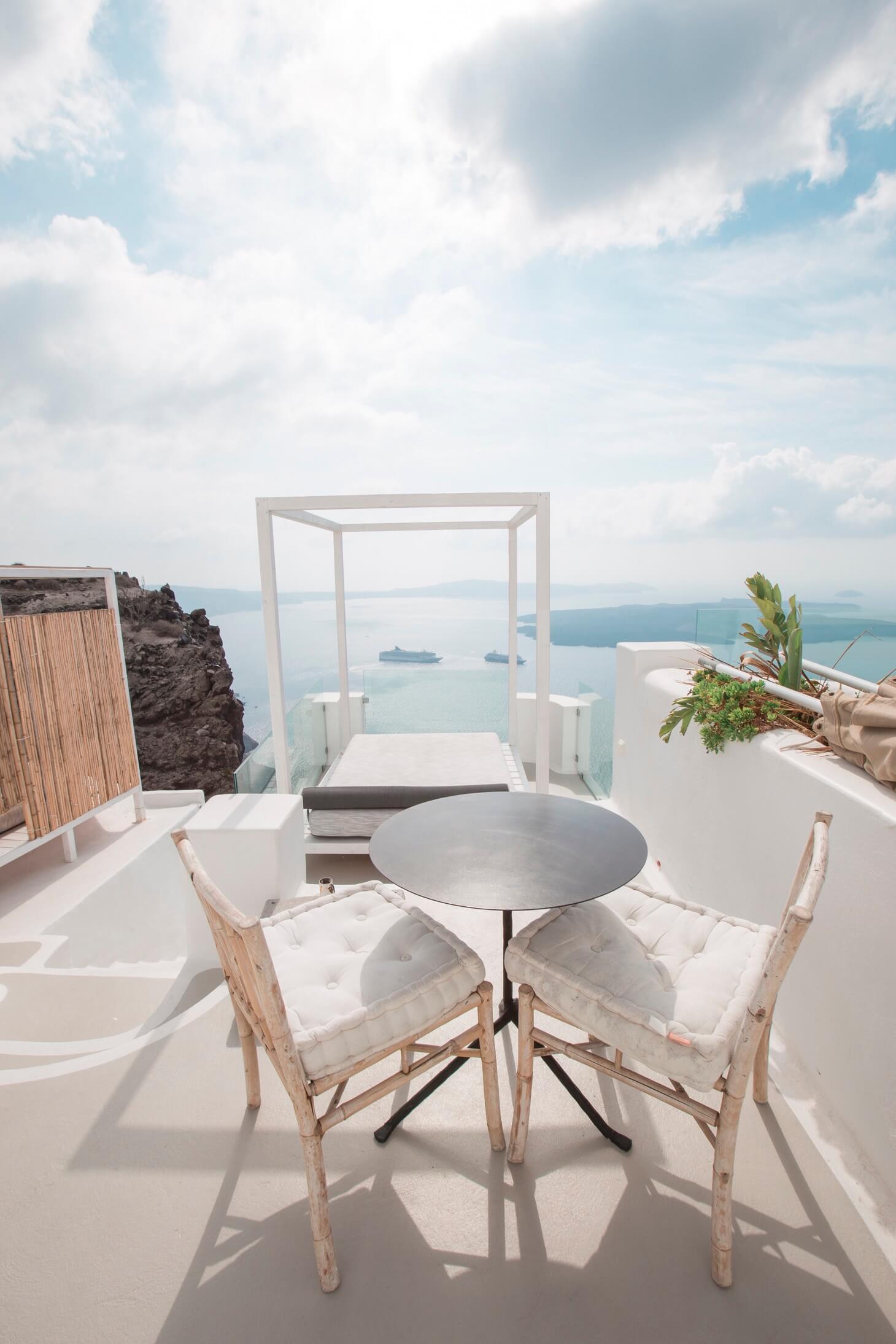 chairs and table for two outside a resort in greece